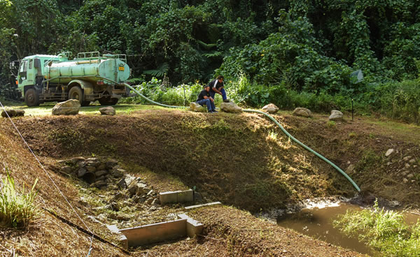 Sucker truck pumping sludge into the Papua residual pond.